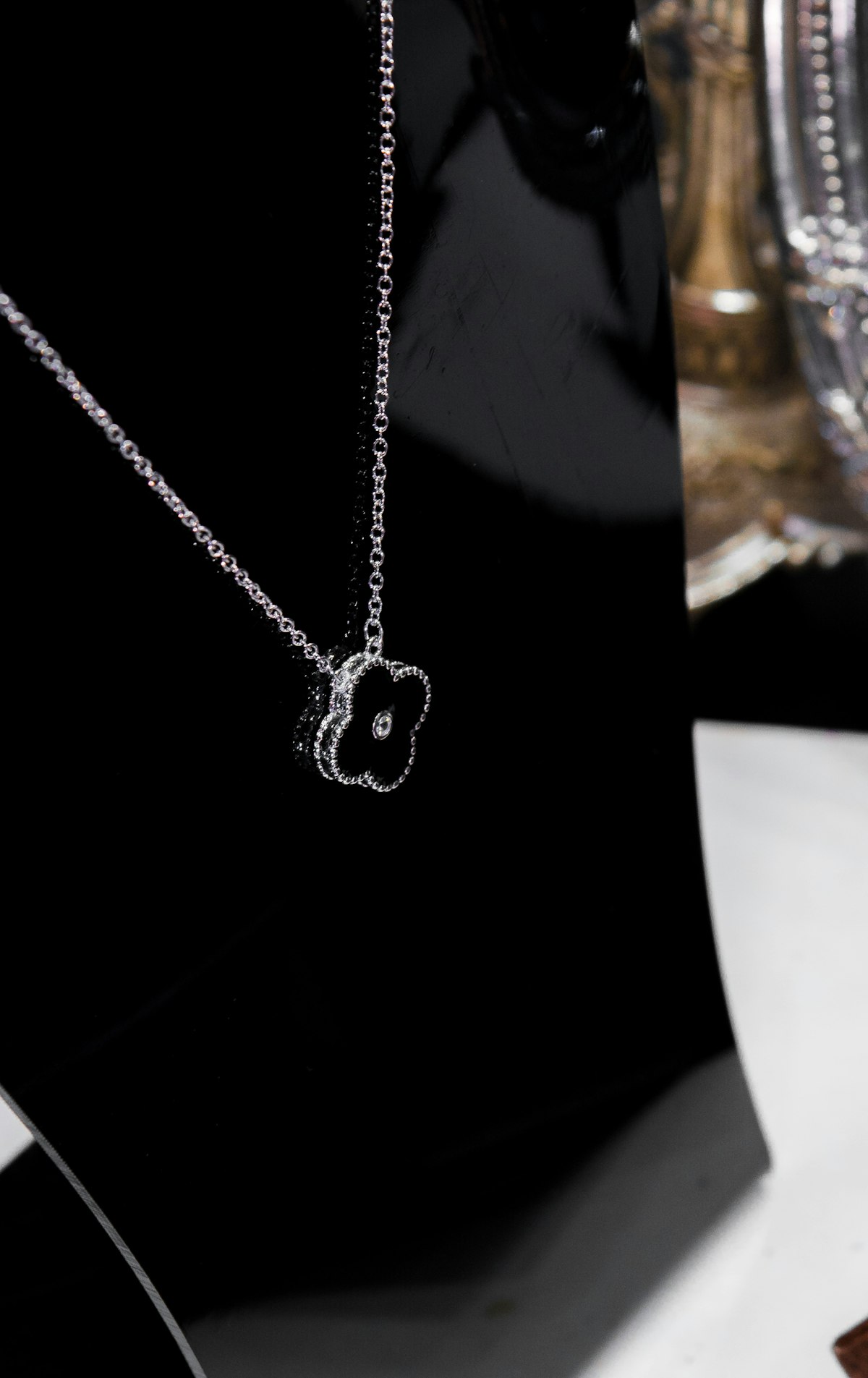 Silver chain necklace on black fabric